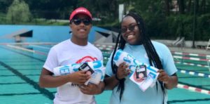 male and female lifeguards smiling and holding Lifeguard Appreciation Week Prizes